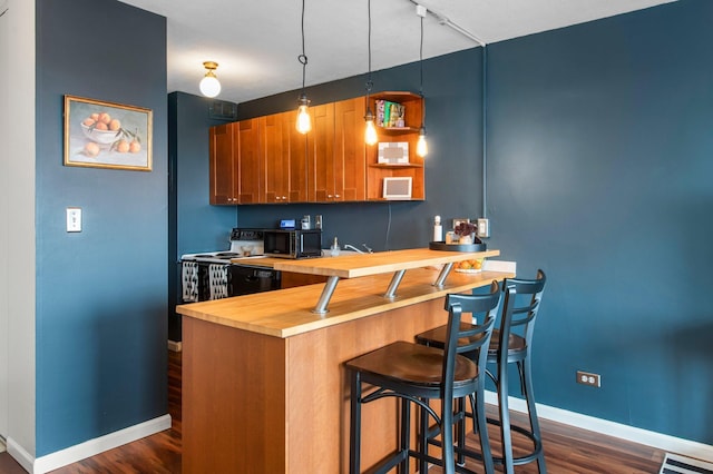 kitchen featuring hanging light fixtures, dark hardwood / wood-style floors, white electric range, and wooden counters