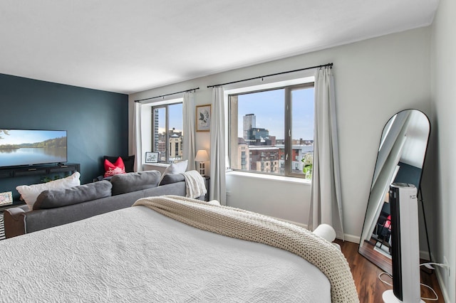 bedroom with dark hardwood / wood-style floors