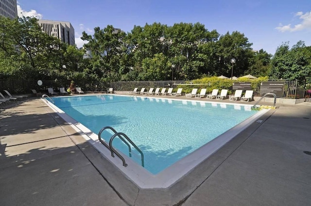 view of swimming pool with a patio