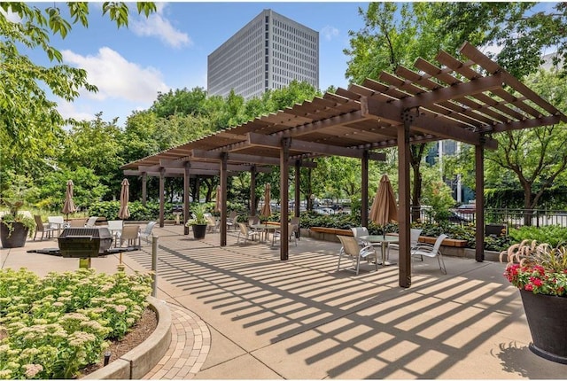 view of home's community with a pergola and a patio