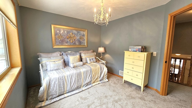 bedroom with baseboards, a chandelier, and carpet flooring