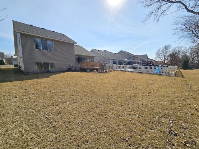 view of yard featuring a deck and fence