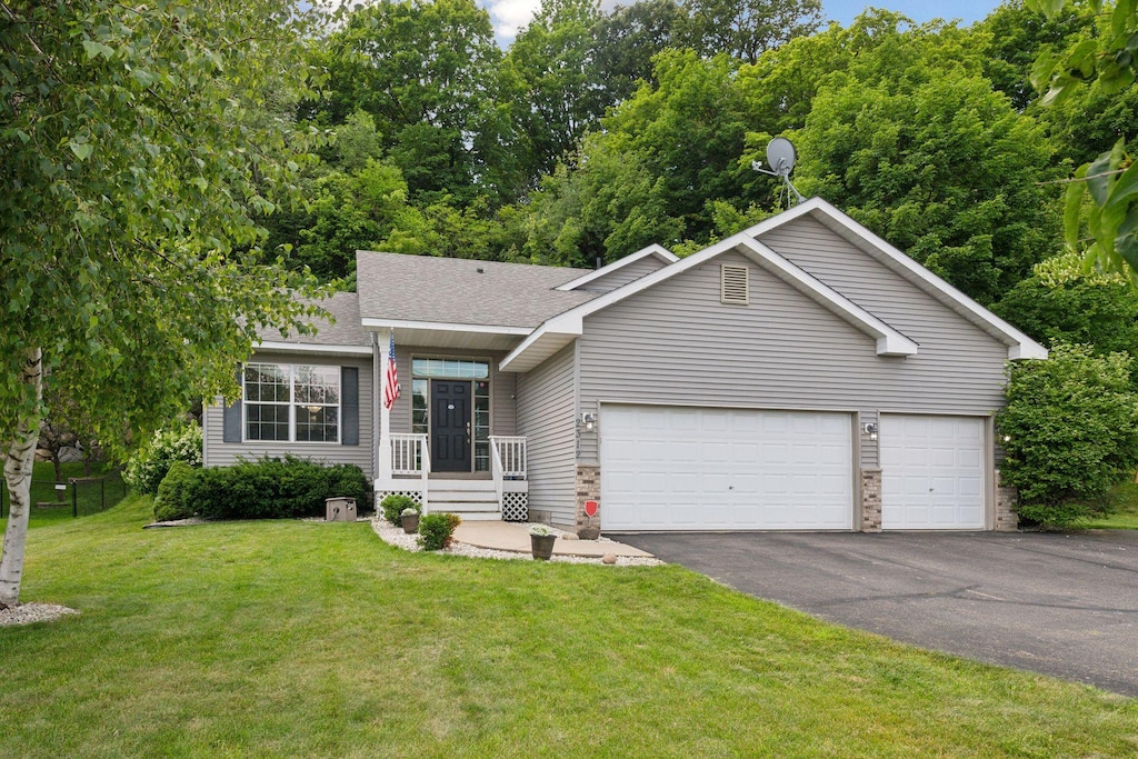 ranch-style home with a garage and a front yard