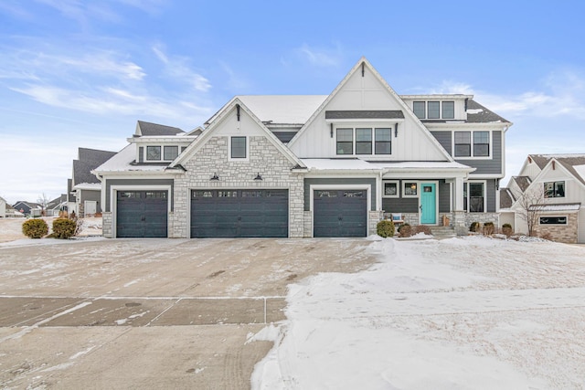 view of front facade with board and batten siding, stone siding, and an attached garage