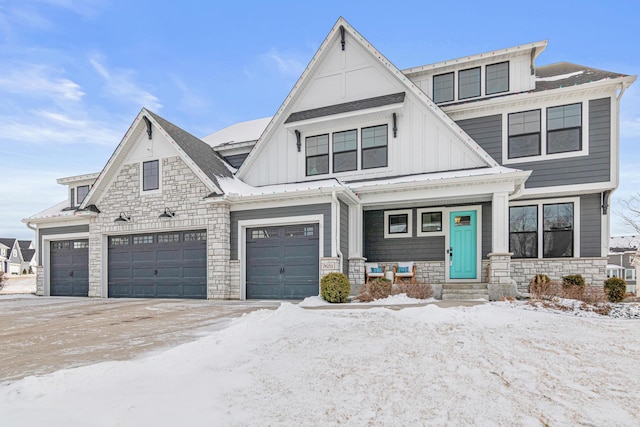 view of front of property with stone siding, board and batten siding, and an attached garage