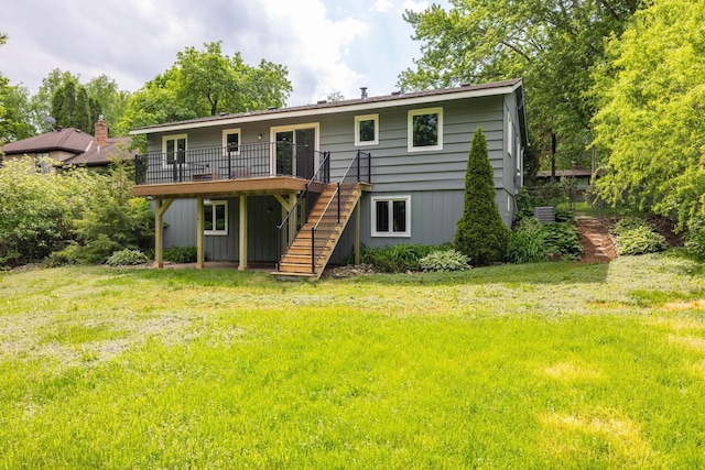 rear view of house featuring a deck and a lawn