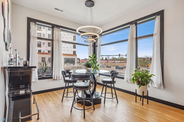 dining room with hardwood / wood-style flooring and a chandelier