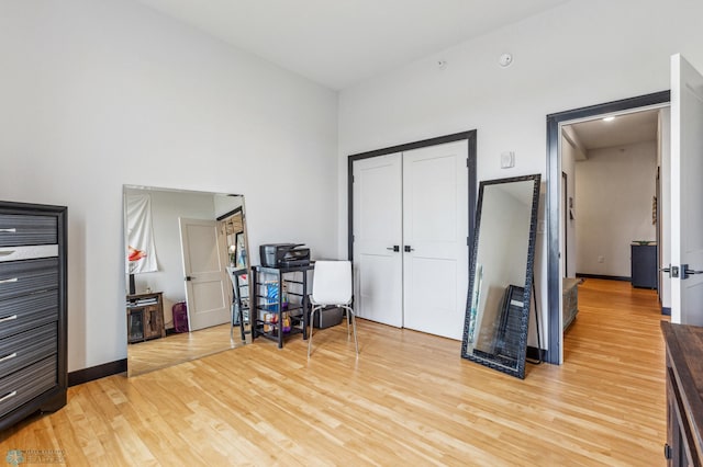 office space with hardwood / wood-style flooring and a high ceiling