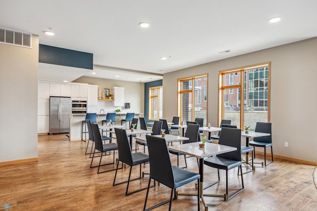 dining space with light hardwood / wood-style floors