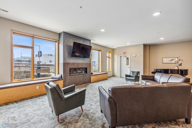 living room featuring light carpet and a fireplace