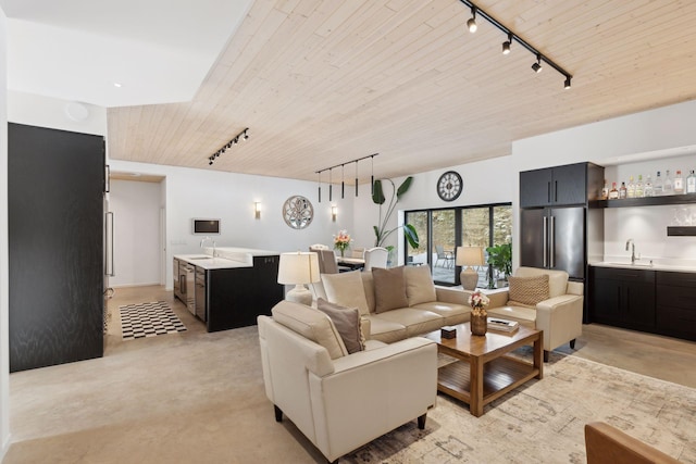 1325 State Highway 27, Ladysmith, WI 54848 - living area featuring rail lighting, wet bar, wooden ceiling, and finished concrete flooring