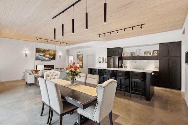 1325 State Highway 27, Ladysmith, WI 54848 - dining room featuring rail lighting, finished concrete flooring, and wooden ceiling