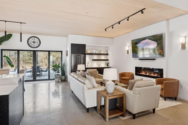 1325 State Highway 27, Ladysmith, WI 54848 - living area with a bar, concrete flooring, a glass covered fireplace, track lighting, and wooden ceiling