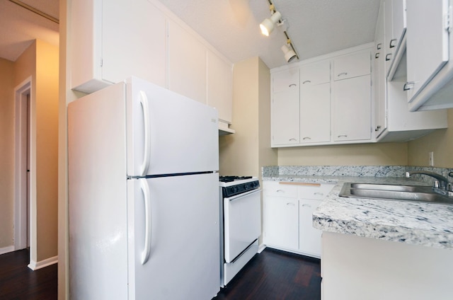 kitchen with white cabinetry, sink, white appliances, and dark wood-type flooring