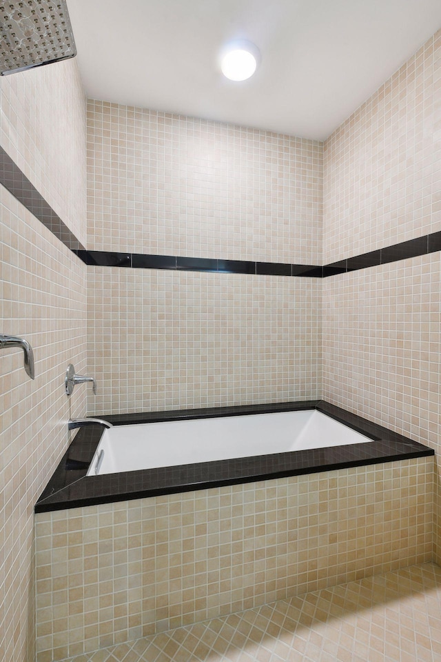 bathroom featuring tiled bath and tile walls