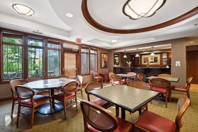 dining area featuring a raised ceiling