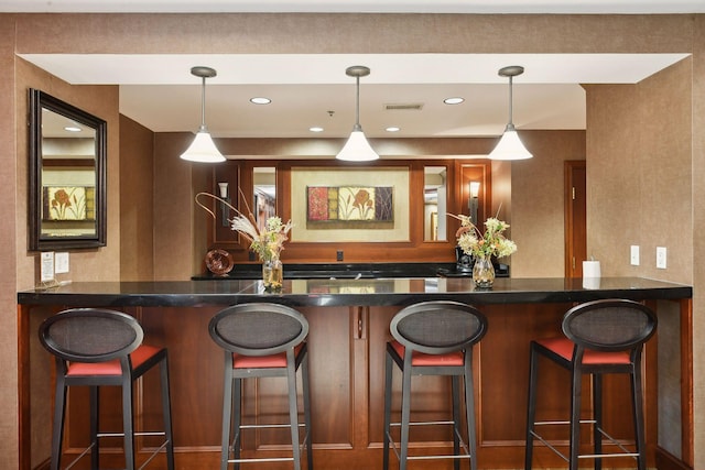 bar featuring hanging light fixtures