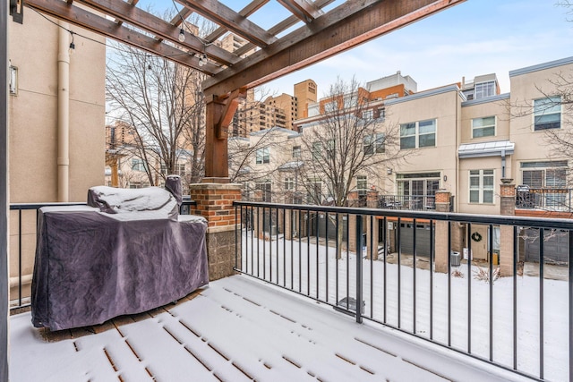 snow covered deck with a pergola