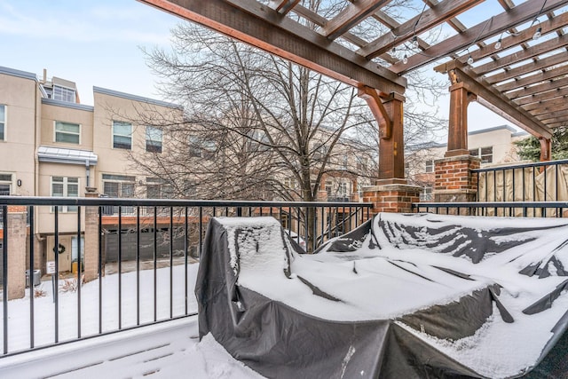 snow covered deck featuring a pergola