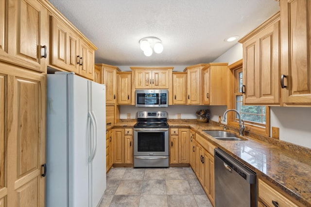 8685 79th St NW, Corinna Twp, MN 55302 - kitchen with appliances with stainless steel finishes, a textured ceiling, light brown cabinets, recessed lighting, and dark stone counters