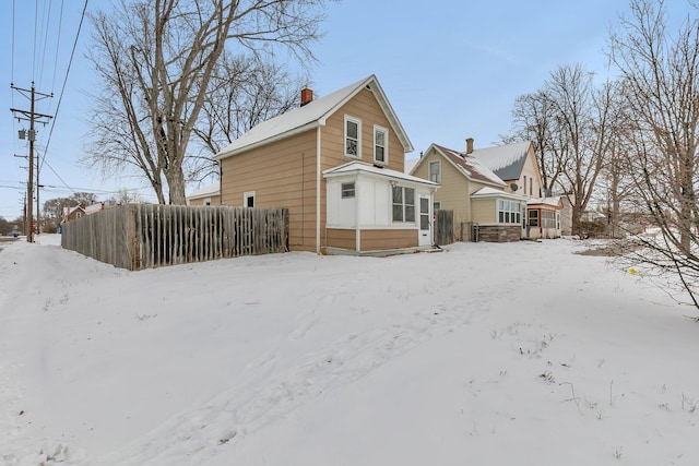 view of snow covered rear of property