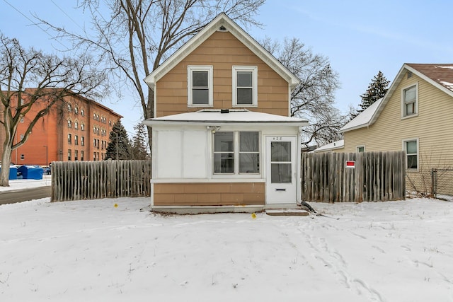 view of snow covered back of property