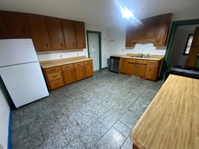 428 10th Ave N, Saint Cloud, MN 56303 - kitchen with freestanding refrigerator, dishwasher, light countertops, a sink, and black gas range oven