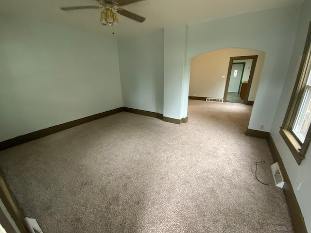 428 10th Ave N, Saint Cloud, MN 56303 - carpeted spare room with arched walkways, ceiling fan, and baseboards