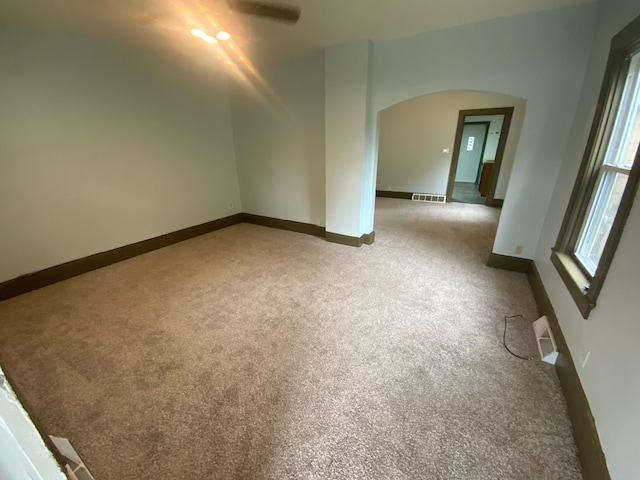 428 10th Ave N, Saint Cloud, MN 56303 - carpeted spare room featuring arched walkways, baseboards, and a ceiling fan