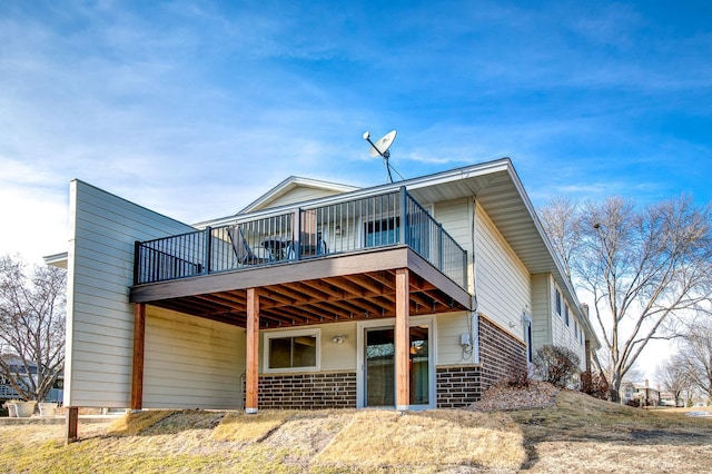 view of front facade with brick siding and a wooden deck