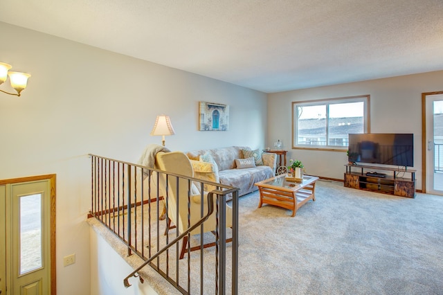 living area with stairs, carpet, baseboards, and a textured ceiling