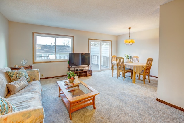 carpeted living room with a textured ceiling and baseboards