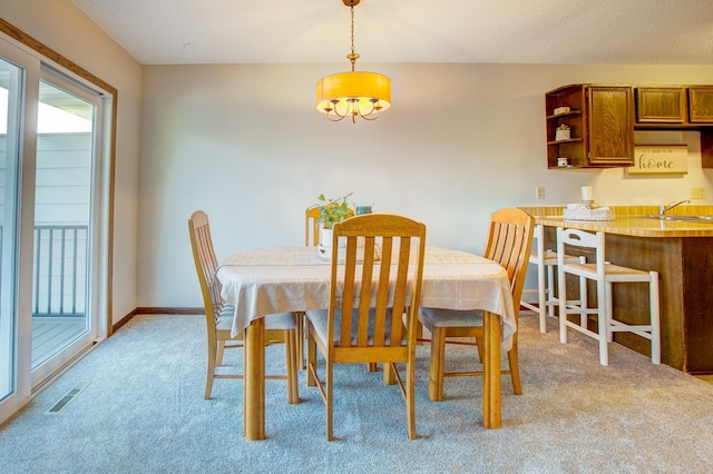 dining area featuring visible vents, plenty of natural light, light colored carpet, and baseboards