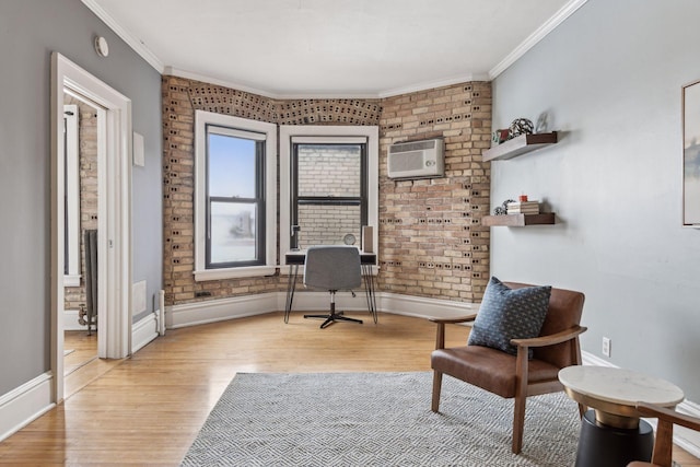 sitting room featuring crown molding, light hardwood / wood-style flooring, a wall mounted AC, and brick wall