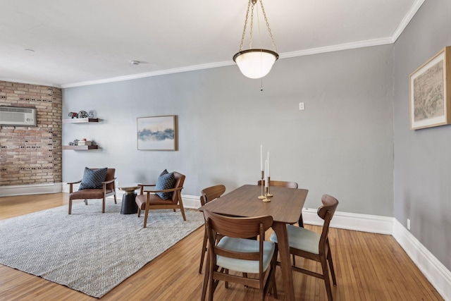 dining space featuring hardwood / wood-style flooring, ornamental molding, and a wall mounted air conditioner