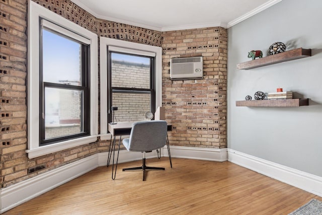 office space with crown molding, brick wall, and light hardwood / wood-style floors