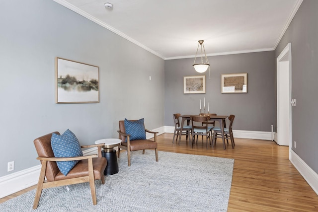 sitting room with crown molding and hardwood / wood-style floors