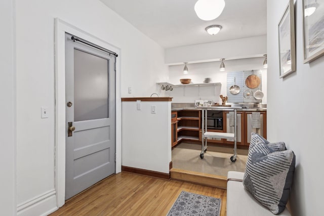 home office with light hardwood / wood-style flooring