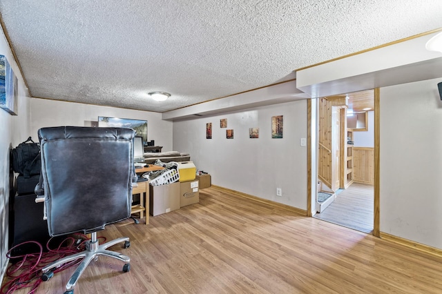 office space featuring a textured ceiling and light wood finished floors