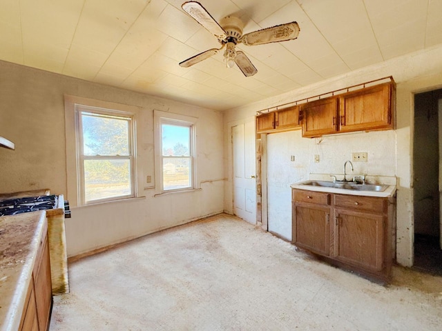 kitchen featuring ceiling fan and sink