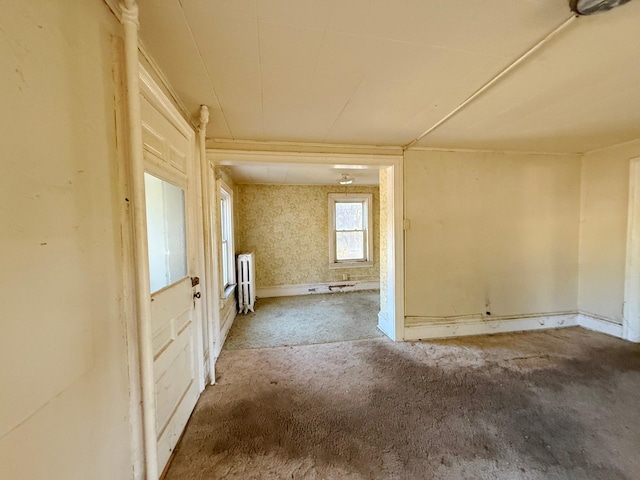 unfurnished room with radiator heating unit