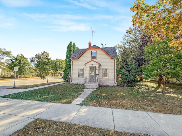 205 Adams St, Hutchinson, MN 55350 - bungalow-style house featuring a front yard, a chimney, and roof with shingles