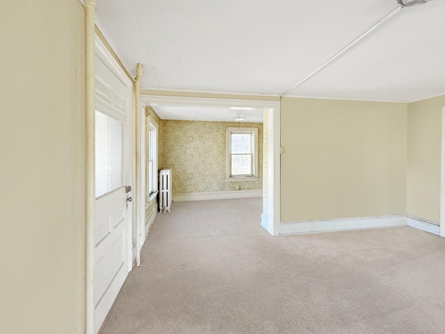 205 Adams St, Hutchinson, MN 55350 - unfurnished room featuring radiator heating unit, light colored carpet, and baseboards