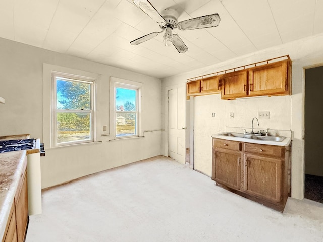 205 Adams St, Hutchinson, MN 55350 - kitchen with a sink, a ceiling fan, brown cabinets, and light countertops