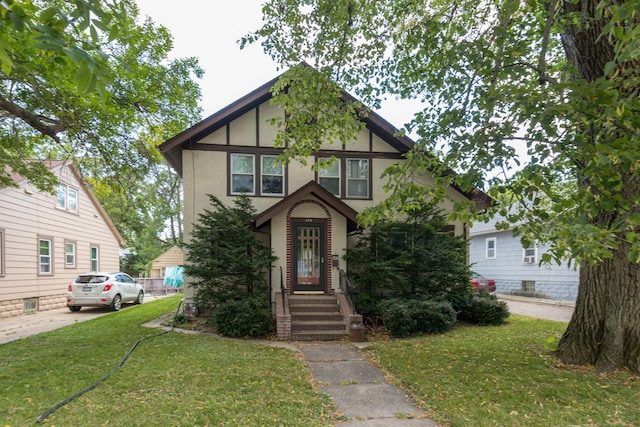 tudor home featuring a front yard