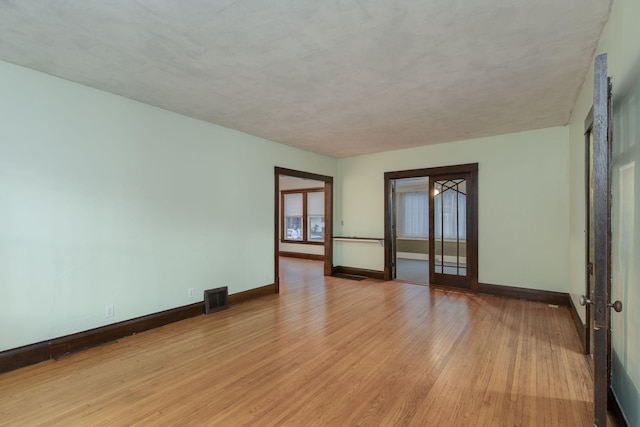 spare room with light hardwood / wood-style floors