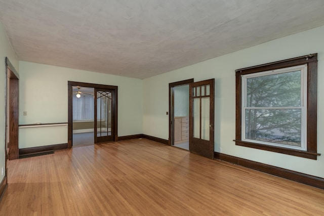 unfurnished room featuring a wealth of natural light and light hardwood / wood-style floors