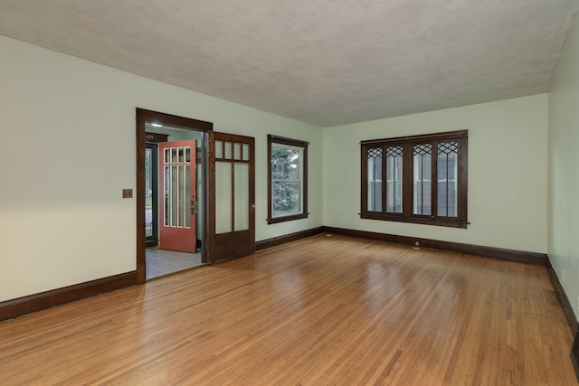 spare room with light hardwood / wood-style flooring