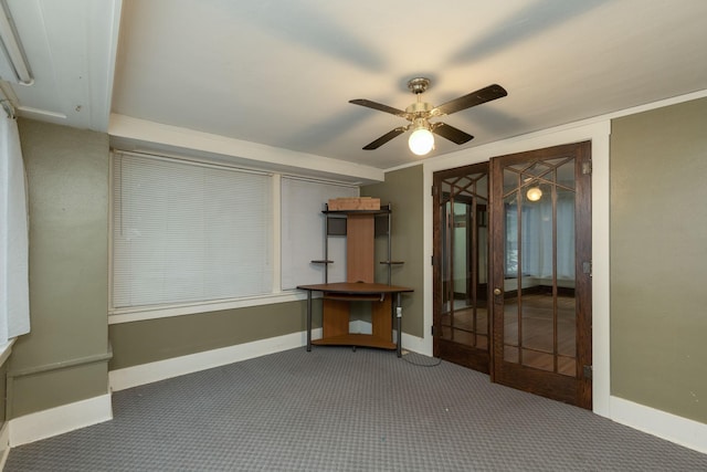 carpeted spare room with crown molding and ceiling fan