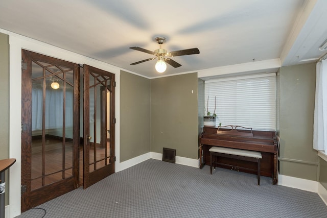 misc room featuring ornamental molding, carpet floors, and ceiling fan